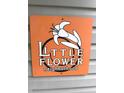 Little Flower neighborhood sign with a simple white flower illustration on a orange background at 1556 N Euclid Ave, Indianapolis, IN 46201