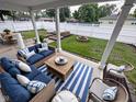 Inviting covered patio features stylish seating, a dining table, and a view of the backyard at 1556 N Euclid Ave, Indianapolis, IN 46201