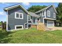 View of the home's exterior with gray siding, white trim and a blue door at 17138 Joliet Rd, Westfield, IN 46074