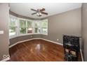 Spacious bedroom with hardwood floors, large windows, and ceiling fan offers natural light and comfortable living at 2325 N Talbott St, Indianapolis, IN 46205