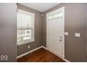 Bright entryway with hardwood floors, a window with blinds, and white door creates a welcoming first impression at 2325 N Talbott St, Indianapolis, IN 46205