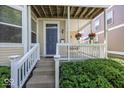 Inviting front porch with hanging flower baskets, swing, and white railings, offers a relaxing outdoor space at 2325 N Talbott St, Indianapolis, IN 46205