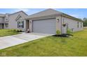 A lovely single-story house with a two-car garage and lush green lawn at 24416 Kercheval St, Sheridan, IN 46069