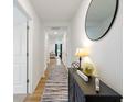 Bright hallway with a decorative table and a rug leading to a living area at 24416 Kercheval St, Sheridan, IN 46069
