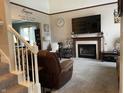Inviting living room features a fireplace, large television, plush seating, and warm, neutral decor at 2925 Morgan Trl, Martinsville, IN 46151