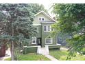 Two-story green home with many trees at 3307 N College Ave, Indianapolis, IN 46205