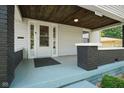 Inviting front porch with painted ceiling offers a cozy outdoor space at 3329 Main St, Anderson, IN 46013
