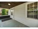 View of the covered front porch, showing the entrance door and wood ceiling at 3329 Main St, Anderson, IN 46013
