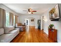 Spacious living room featuring hardwood floors, a ceiling fan, and neutral walls at 3329 Main St, Anderson, IN 46013