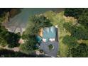 Overhead view showcasing the roof, driveway, and surrounding landscape of a private lake home at 4126 E Rembrandt Dr, Martinsville, IN 46151