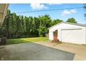 Detached garage with a white exterior and a spacious driveway at 4221 Haverhill Dr, Anderson, IN 46013