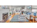 Bright living room boasts hardwood floors, a decorative fireplace, and stylish furnishings at 4732 N Kenwood Ave, Indianapolis, IN 46208