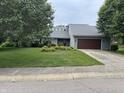 Charming home featuring a well-manicured lawn and an attached two-car garage at 4760 Winterberry Pl, Columbus, IN 47201