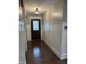 Inviting entryway boasting wainscoting, modern lighting, and stunning hardwood floors at 4760 Winterberry Pl, Columbus, IN 47201