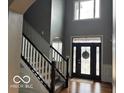 Grand two-story foyer features a staircase and ornate glass front door, welcoming you into this charming home at 4931 Kerrington Blvd, Bargersville, IN 46106