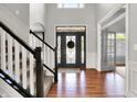 Grand foyer showcasing hardwood floors, staircase with white banister, and decorative front door at 4931 Kerrington Blvd, Bargersville, IN 46106