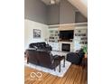 Cozy living room boasts a fireplace, built-in shelves, and hardwood floors, perfect for relaxation at 4931 Kerrington Blvd, Bargersville, IN 46106