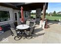 Inviting outdoor patio with stone fireplace, dining table, seating and built-in grill perfect for entertaining at 4931 Kerrington Blvd, Bargersville, IN 46106
