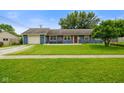 Well-kept single-story home with a large front lawn and attached garage at 50 Crestview Dr, Greenwood, IN 46143