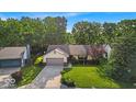 Inviting single-story home with lush green lawn and mature trees for added curb appeal at 5010 Donner Ln, Indianapolis, IN 46268