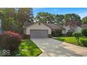 Charming ranch-style home featuring a well-manicured lawn and an attached two-car garage at 5010 Donner Ln, Indianapolis, IN 46268