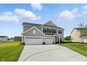 Charming home with a large driveway and green lawn on a sunny day surrounded by other homes at 5763 Greenbrier Ct, Brownsburg, IN 46112