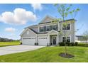 Attractive two-story home with a three-car garage, green lawn, and vibrant landscaping, set in a serene neighborhood at 5763 Greenbrier Ct, Brownsburg, IN 46112