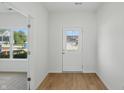 Bright foyer featuring wood-look flooring, a white door with glass panes, and a view to the outside at 5763 Greenbrier Ct, Brownsburg, IN 46112