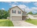 Well-maintained two-story home featuring a spacious driveway, attached garage, and vibrant lawn at 6635 Blackthorn Dr, Indianapolis, IN 46221
