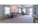 Bright living room with neutral paint, plush carpet, and comfortable seating for relaxation at 6635 Blackthorn Dr, Indianapolis, IN 46221