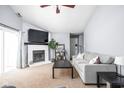 Bright living room with a cozy fireplace, a large television, and comfortable seating at 6637 Sundown S Dr, Indianapolis, IN 46254