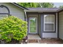 Inviting front entrance features a storm door, brick walkway and lush landscaping at 7239 Wet Rock Ct, Indianapolis, IN 46236