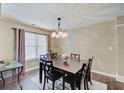 Cozy dining room boasting a stylish chandelier, dark wood table and six chairs at 7372 Oakview Dr, Avon, IN 46123