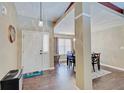 Inviting entryway featuring hardwood floors, a welcome mat and a view to the dining room at 7372 Oakview Dr, Avon, IN 46123