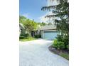 Charming home featuring a light blue garage door and a tree in the front yard at 7470 Charrington Ct, Indianapolis, IN 46254