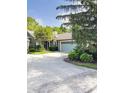 Charming home featuring a light blue garage door and a tree in the front yard at 7470 Charrington Ct, Indianapolis, IN 46254