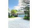 Charming home featuring a light blue garage door and a tree in the front yard at 7470 Charrington Ct, Indianapolis, IN 46254