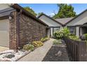 Landscaped walkway featuring lovely plants that lead to a charming home at 7616 Derrek Pl, Indianapolis, IN 46219