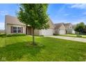 A quaint home with a lush green lawn in a neighborhood setting beneath a bright blue sky at 7715 Bolero Dr, Camby, IN 46113