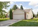 Charming single-story home featuring a two-car garage, front yard and brick accents at 779 Alvey Ct, Greenwood, IN 46143