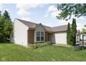 Charming single-story home featuring neutral siding, brick accents and a well manicured front lawn at 779 Alvey Ct, Greenwood, IN 46143