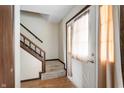 Inviting entryway featuring a staircase, wood accents, and a front door with natural light at 8306 Corkwood Dr, Indianapolis, IN 46227