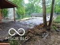 Exterior shot showing damage between the house and detached garage structure at 8803 S Sleepy Hollow Rd, Waldron, IN 46182