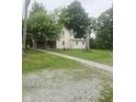 Charming two-story home featuring a quaint porch and a long driveway leading to the property at 9024 W Mooresville Rd, Indianapolis, IN 46113
