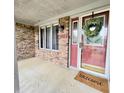 Inviting front porch with a red front door, brick accents, and a 'Welcome' mat at 907 Corey Ln, Plainfield, IN 46168