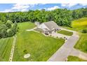 Expansive property showcasing a well-maintained home, lush greenery, outbuilding and long driveway at 9231 E Poynter Dr, Morgantown, IN 46160