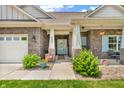 Inviting front entrance featuring a charming blue door, brick facade, and well-kept landscaping at 9231 E Poynter Dr, Morgantown, IN 46160