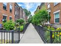 Neighborhood street featuring lovely brick townhomes with manicured lawns at 9508 Oakley Dr, Indianapolis, IN 46260