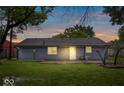 Image shows the back of the house with gray siding and a grassy backyard at 9526 Burrwood Ct, Indianapolis, IN 46235