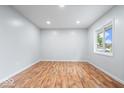 Inviting bedroom showcasing hardwood floors, natural light, and fresh, white walls at 9526 Burrwood Ct, Indianapolis, IN 46235
